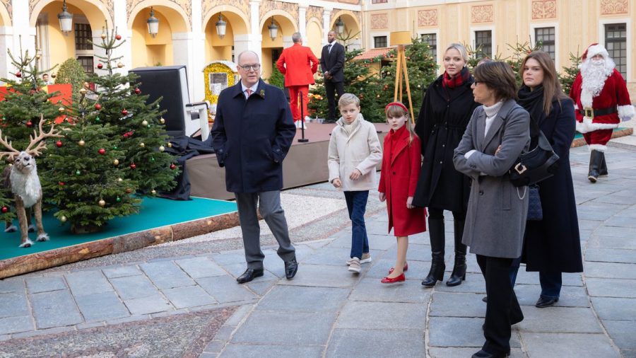 Fürst Albert und seine Familie auf dem Weg zur Geschenkaktion im Ehrenhof des Fürstenpalastes - Prinzessin Gabriella leuchtet mit den Weihnachtsmännern um die Wette. (ili/spot)